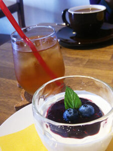 ブルーベリーソースが乗ったデザートとアイスティー。